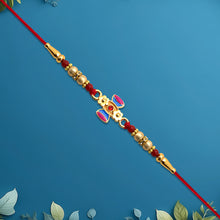 Damru Rakhi With Beads And Floral Detailing