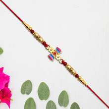 Damru Rakhi With Beads And Floral Detailing
