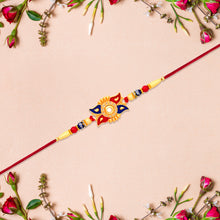 Designer Sun Motif Rakhi With Red And Blue Enamel Work